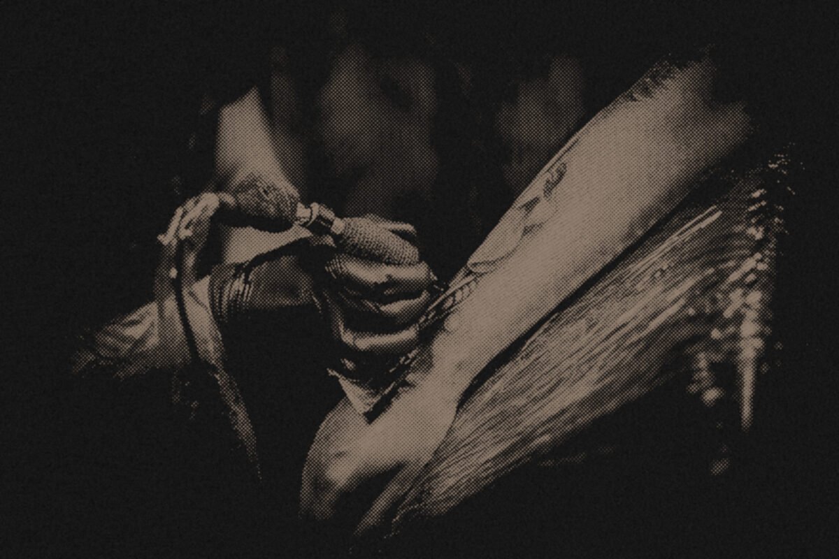 A tattoo artist working on a client
