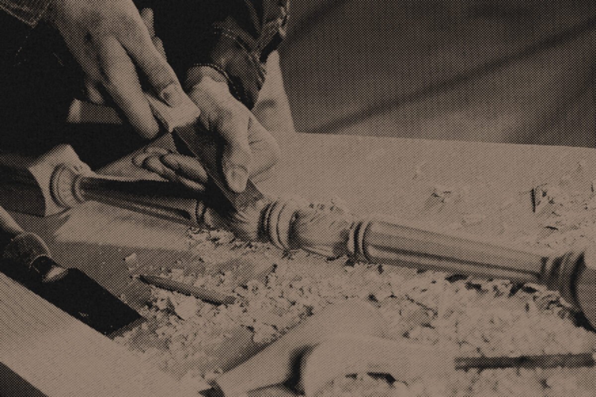 A woodworker turning a spindle on a lathe