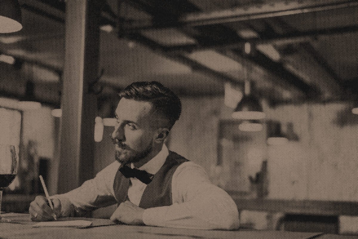 A writer working in a notebook at a bar